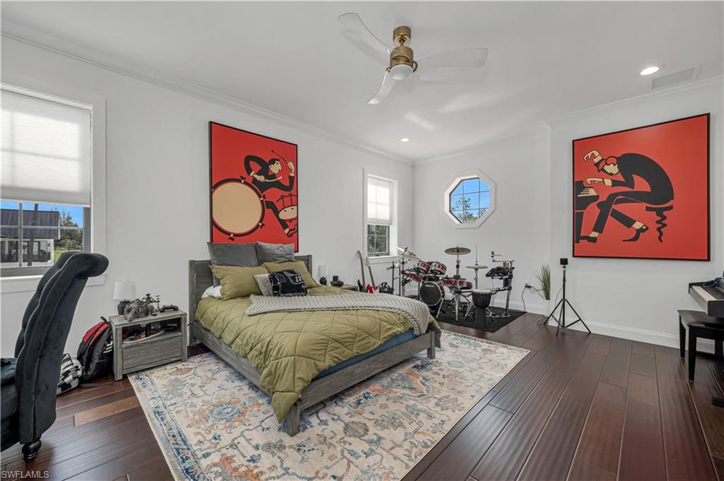 6689 Hunters Road Naples, FL 34109 - Photo 27 of 35 a living room with a couch and dresser with wooden floor