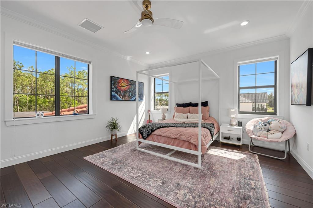 6689 Hunters Road Naples, FL 34109 - Photo 29 of 35 a bedroom with bed couch and window