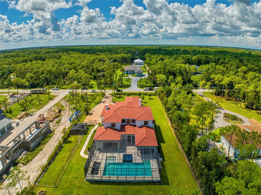 6689 Hunters Road Naples, FL 34109 - Photo 35 of 35 a view of a swimming pool with a yard