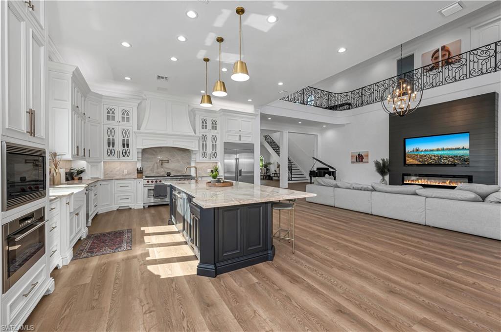6689 Hunters Road Naples, FL 34109 - Photo 7 of 35 a large kitchen with cabinets