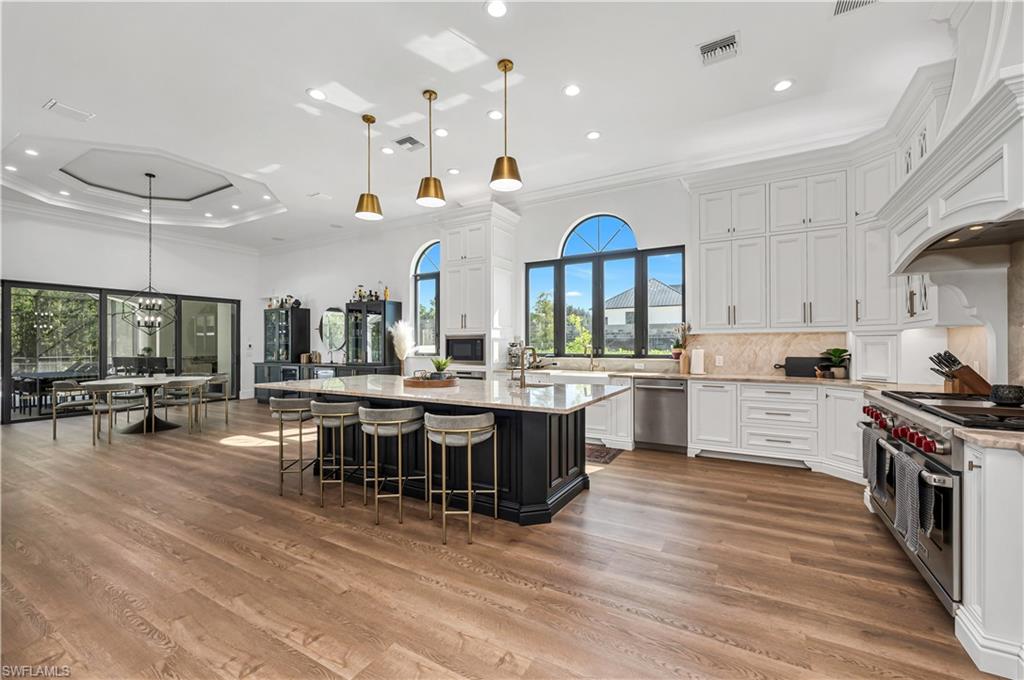 6689 Hunters Road Naples, FL 34109 - Photo 8 of 35 a large kitchen with a table and chairs in it