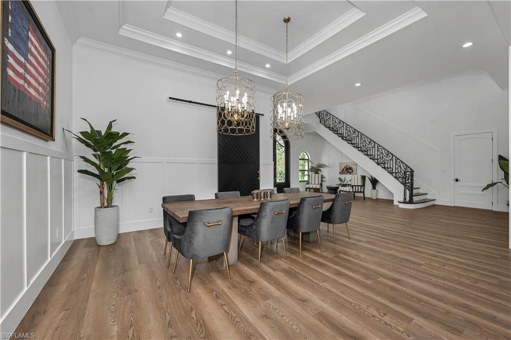 6689 Hunters Road Naples, FL 34109 - Photo 9 of 35 a living room with furniture and a large window