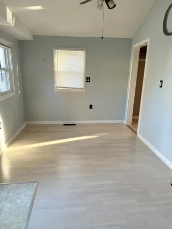 a view of a livingroom with wooden floor and staircase