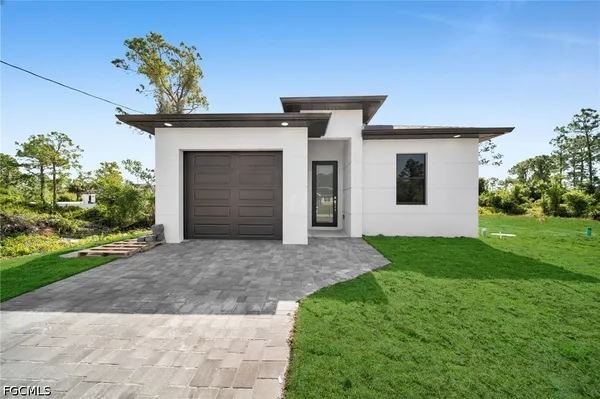 a front view of a house with a yard and garage