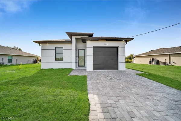 a front view of a house with a yard and garage