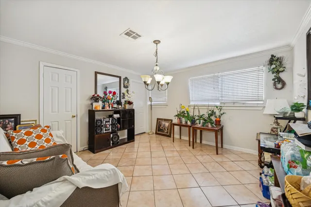 a living room with furniture and a chandelier