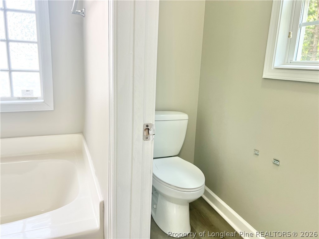 1523 Rough Rider Lane Parkton, NC 28371 - Photo 31 of 42 a white toilet sitting next to a window