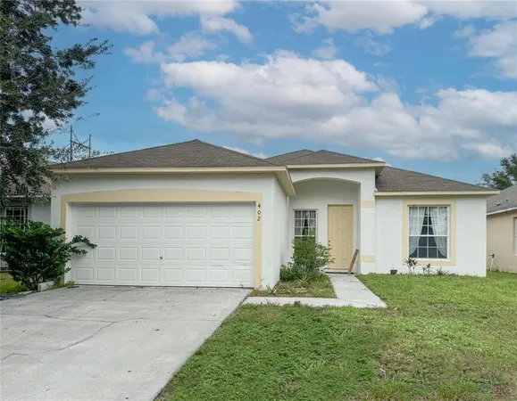 front view of the house with a yard