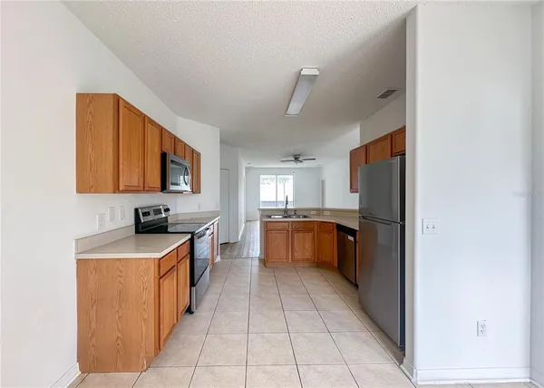 a kitchen with a stove a sink and a refrigerator