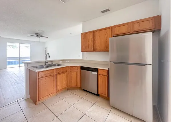 a kitchen with stainless steel appliances granite countertop a refrigerator sink and cabinets