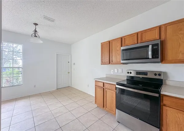 a kitchen with stainless steel appliances a sink dishwasher stove and microwave