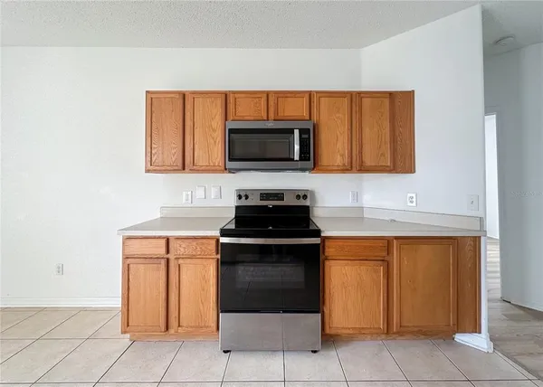 a kitchen with granite countertop white cabinets and stainless steel appliances