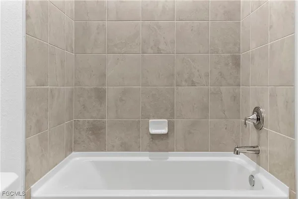 a bathroom with a granite countertop sink and vanity