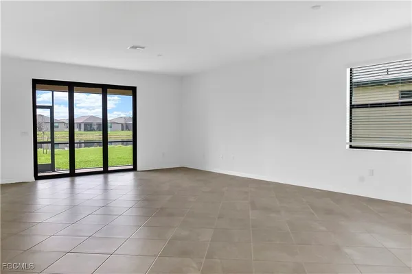 a kitchen with granite countertop white cabinets and a sink