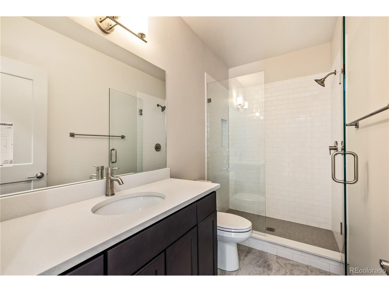 624 Montezuma Road, Unit 3 Keystone, CO 80435 - Photo 17 of 36 a bathroom with a shower sink vanity mirror and toilet