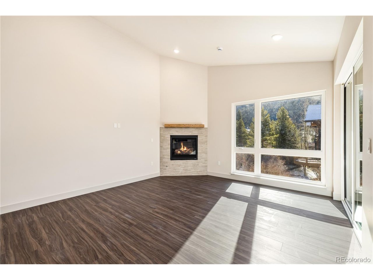 624 Montezuma Road, Unit 3 Keystone, CO 80435 - Photo 2 of 36 a view of an empty room with wooden floor and a window