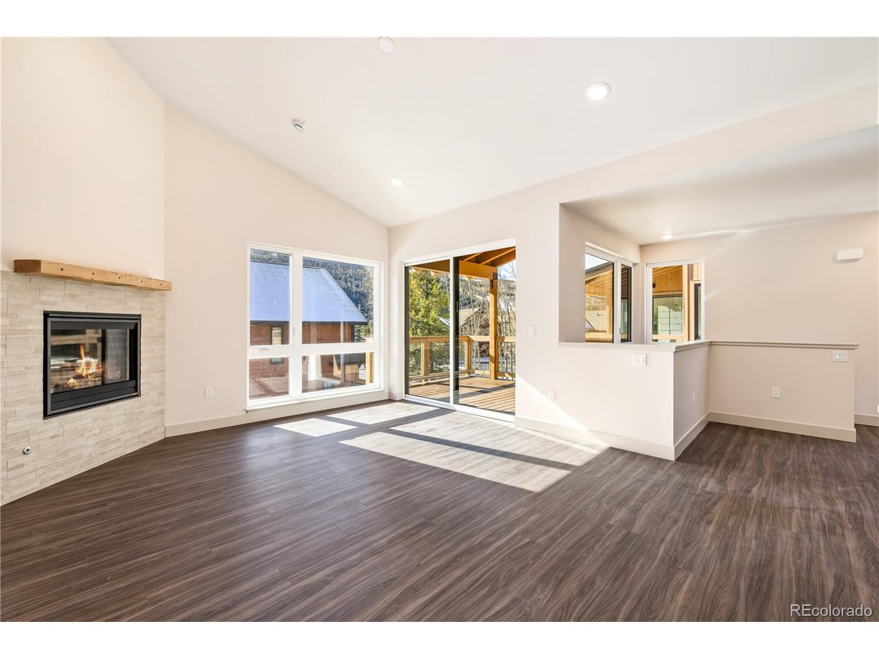624 Montezuma Road, Unit 3 Keystone, CO 80435 - Photo 3 of 36 a view of an empty room with wooden floor and a window