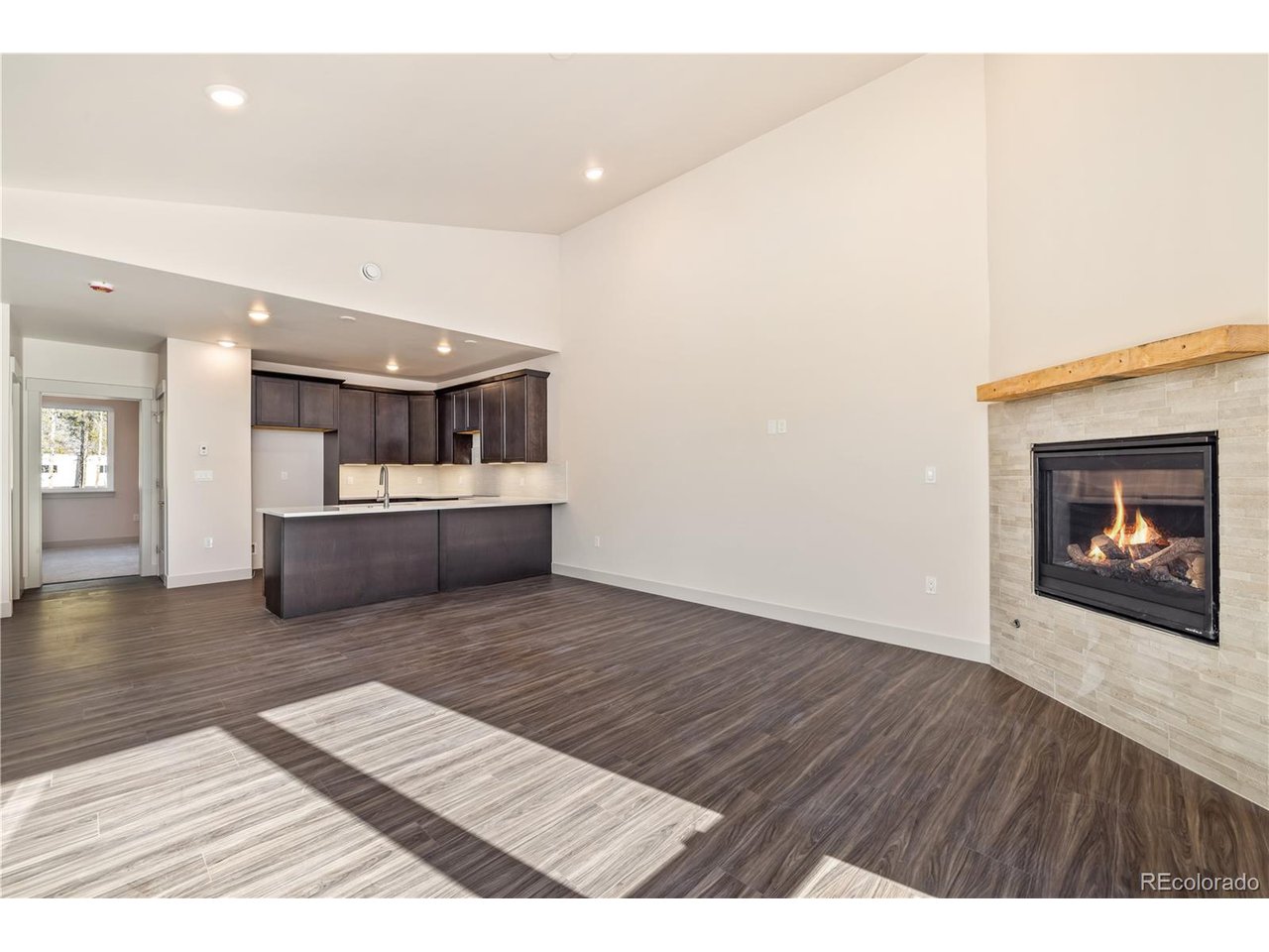 624 Montezuma Road, Unit 3 Keystone, CO 80435 - Photo 4 of 36 a view of kitchen and empty room with wooden floor