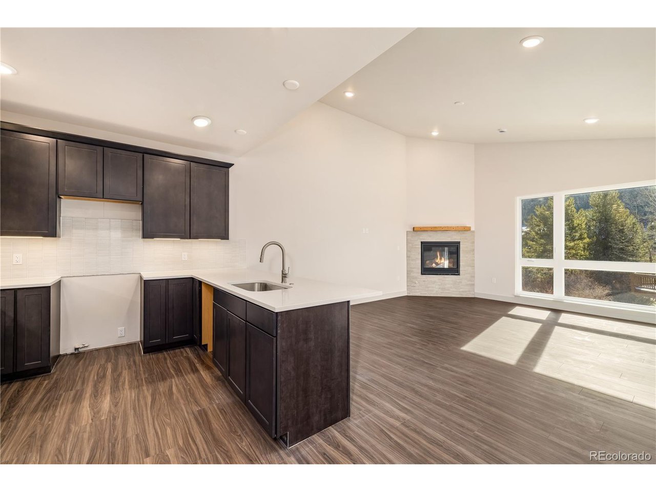 624 Montezuma Road, Unit 3 Keystone, CO 80435 - Photo 6 of 36 a view of a kitchen with a sink and wooden floor