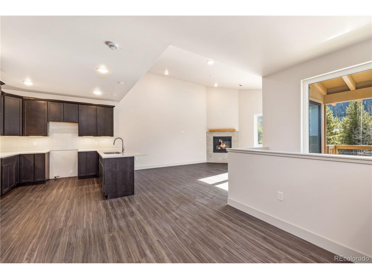 624 Montezuma Road, Unit 3 Keystone, CO 80435 - Photo 8 of 36 a view of a kitchen with kitchen island a sink wooden floor and a window