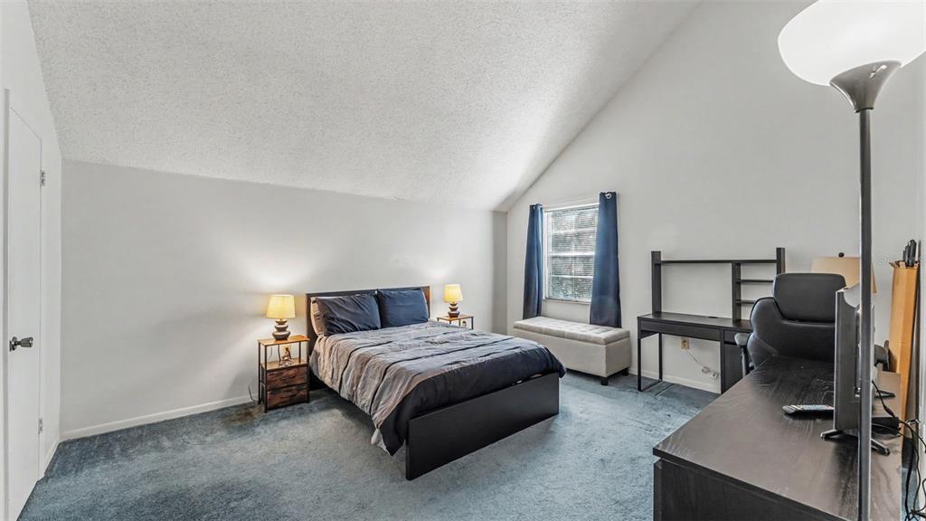 2025 Sylvester Road, Unit N305 Lakeland, FL 33803 - Photo 15 of 34 a bedroom with a bed a desk and chair