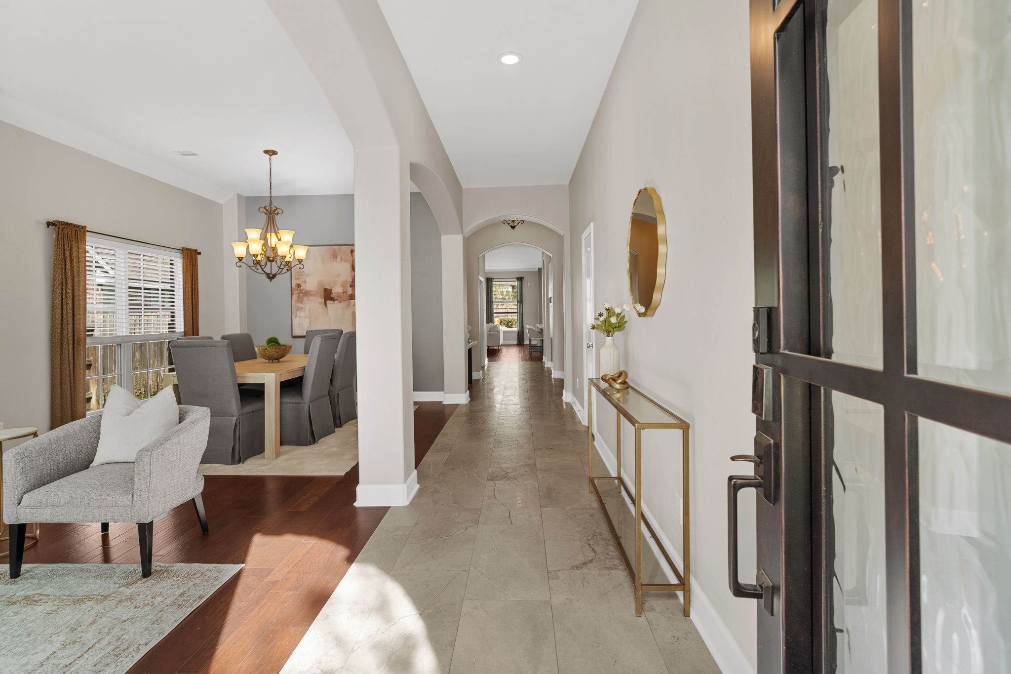 3426 Summer Ranch Drive Katy, TX 77494 - Photo 3 of 48 Step inside to a bright and inviting foyer featuring soaring ceilings, elegant archways, and soft neutral finishes that create an immediate sense of space and sophistication.