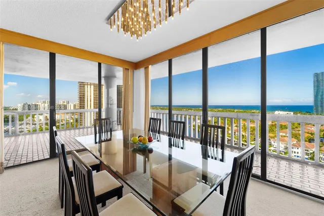 a view of a dining room with furniture water view and balcony