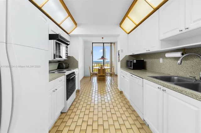 a kitchen with a sink and a stove top oven