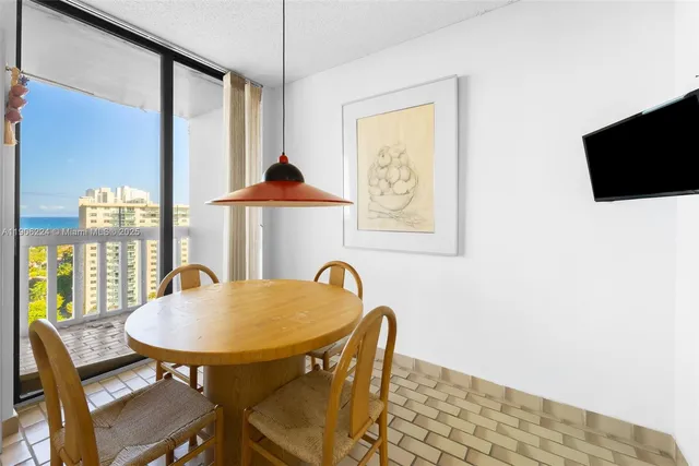 a view of a dining room with furniture and a window