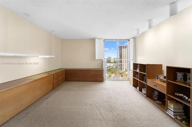 a view of workspace with furniture and book shelf