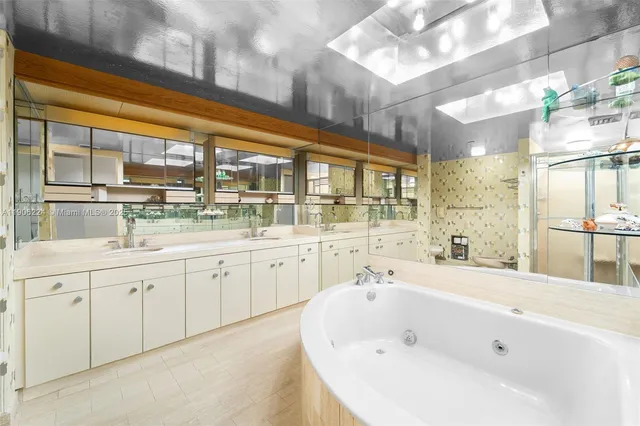 a bathroom with a sink mirror and a bathtub