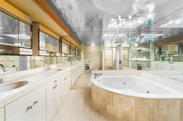 a bathroom with a tub sink and mirror