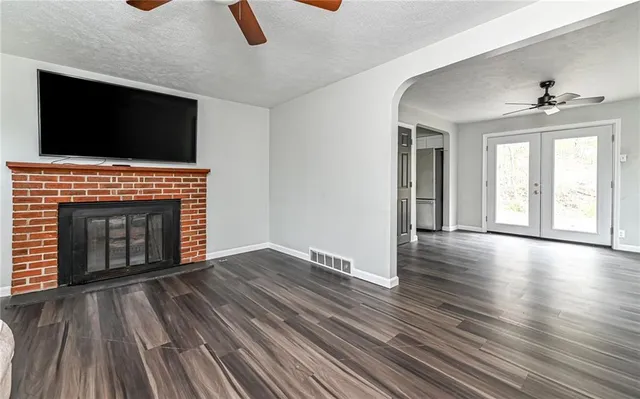 wooden floor fireplace and windows in a room