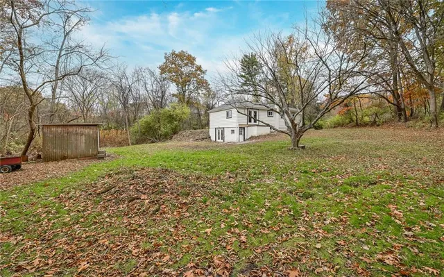 a view of a backyard with large trees