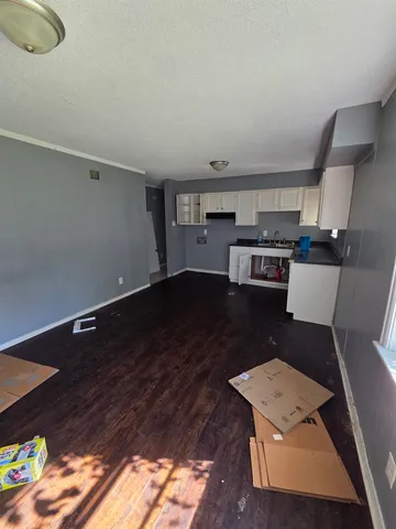 a open kitchen with a sink dishwasher stove and cabinets