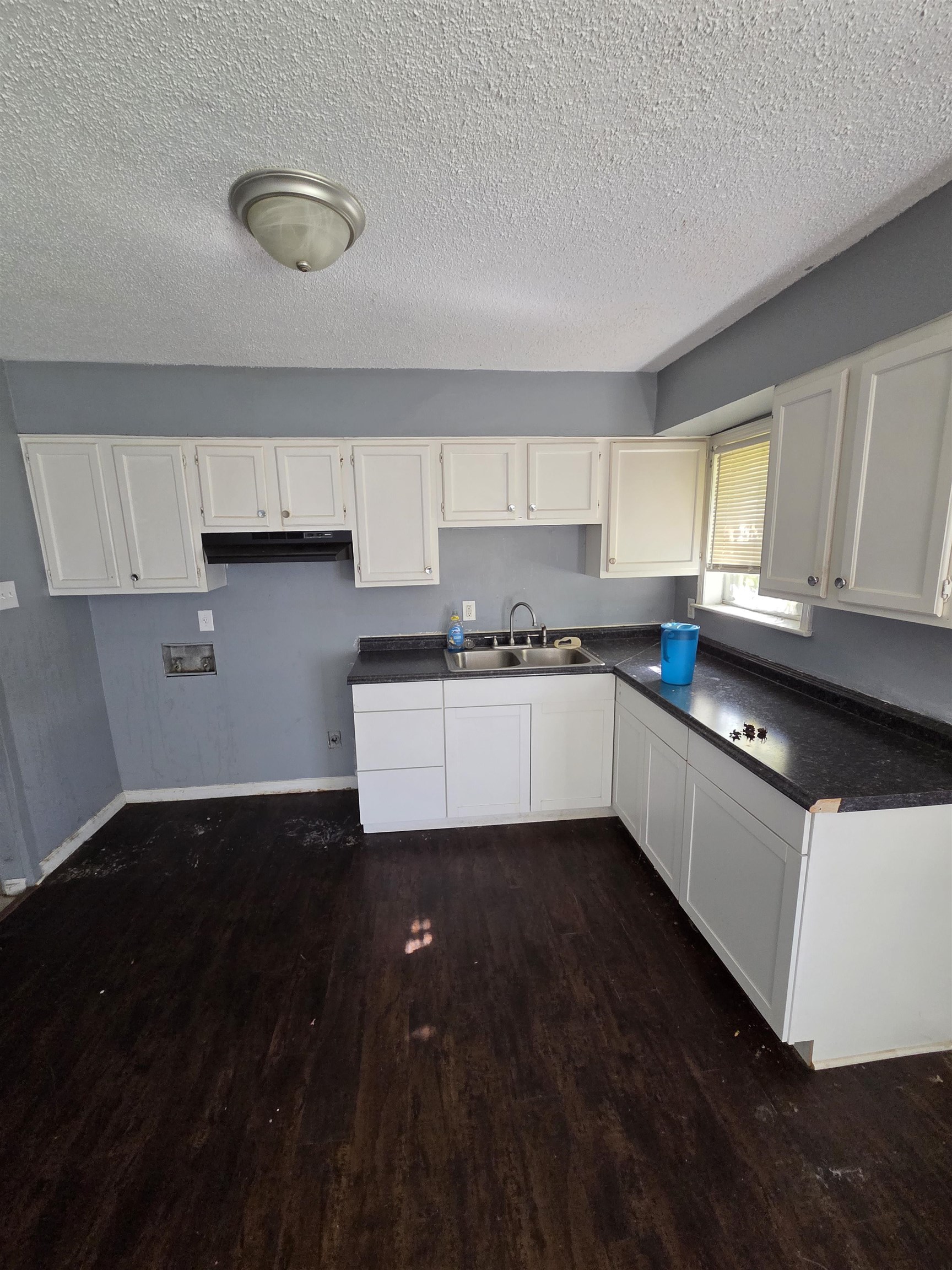 493 Tonawanda Cove Memphis, TN 38109 - Photo 7 of 15 a kitchen with a sink a window and cabinets