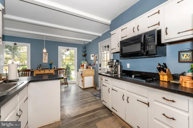 a large white kitchen with stainless steel appliances