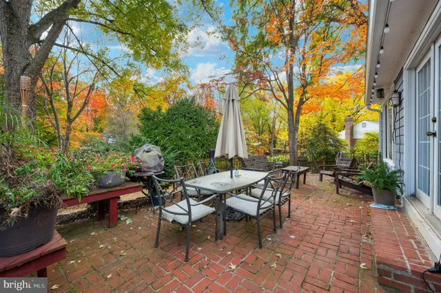 a view of a patio with table and chairs and potted plants