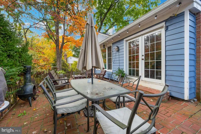 a view of a patio with a table and chairs in a patio