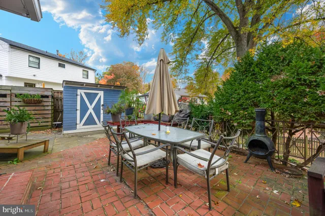 a view of a patio with table and chairs and potted plants