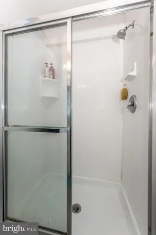 a bathroom with a glass shower door