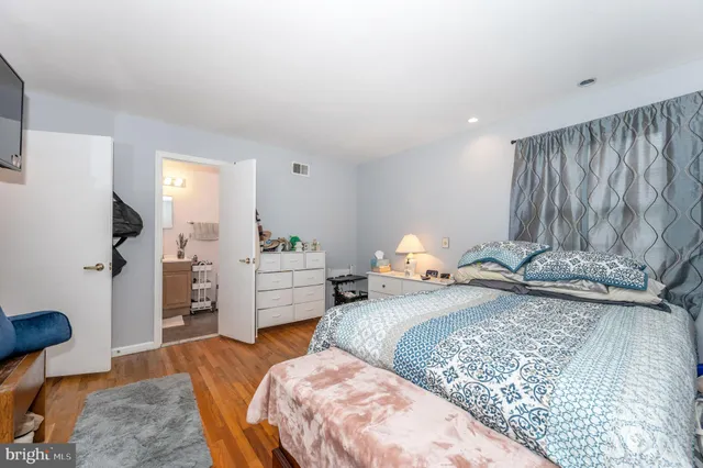 a bedroom with a bed and a dresser