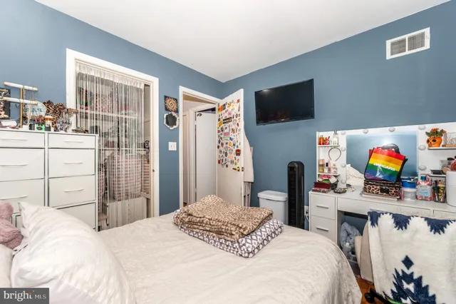 a bedroom with a bed and a flat screen tv