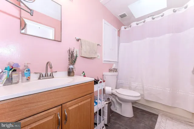 a bathroom with a sink a toilet a mirror and vanity