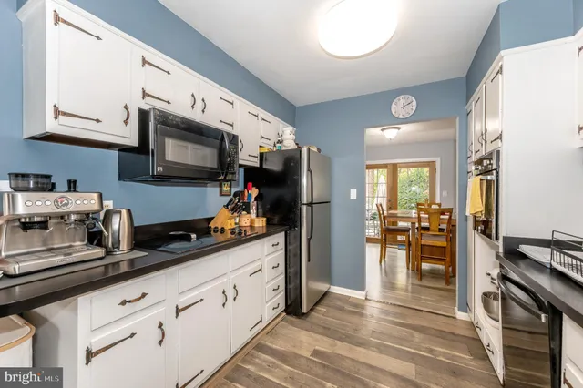 a kitchen with stainless steel appliances granite countertop a refrigerator stove and sink