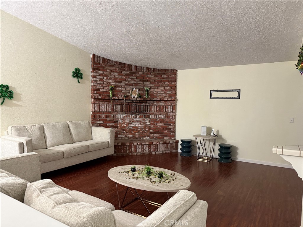 7653 Phelan Road Phelan, CA 92371 - Photo 7 of 10 a living room with furniture and a wooden floor