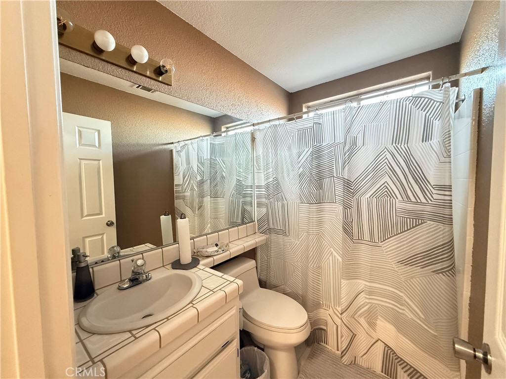 7653 Phelan Road Phelan, CA 92371 - Photo 9 of 10 a bathroom with a sink toilet and shower