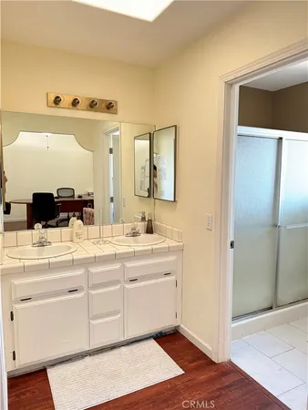 a spacious bathroom with a sink and a mirror