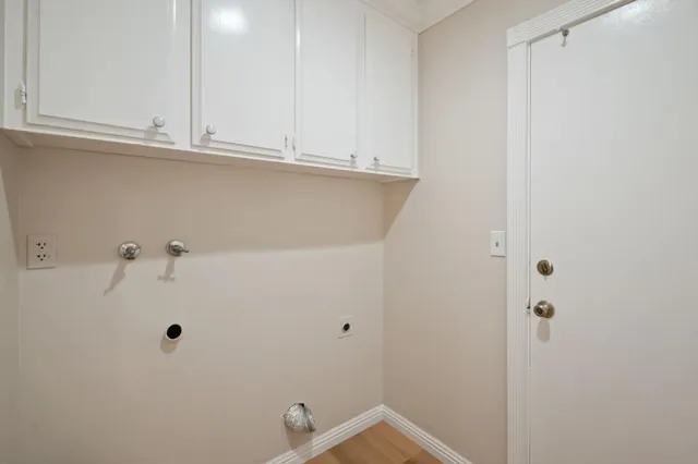 a view of a kitchen with white cabinets