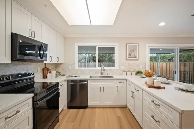 a kitchen with a stove a sink and a microwave